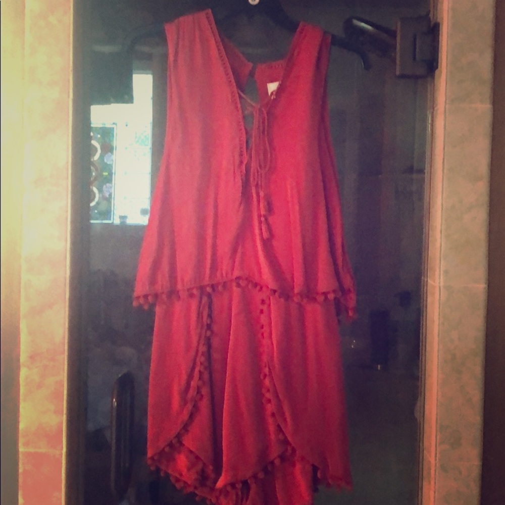 Scarlet romper with open back,front tie and fringe